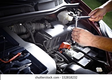 Auto Mechanic Working In Garage. Repair Service.