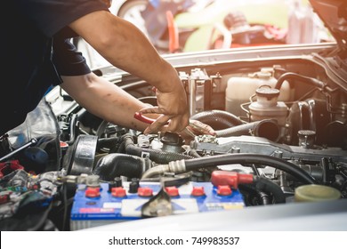 Auto mechanic working in garage. Repair service. - Powered by Shutterstock