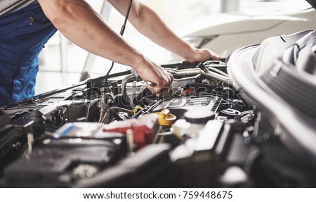 Auto mechanic working in garage. Repair service. Сток-фото © 