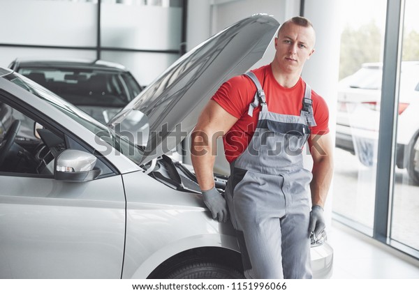 Auto mechanic\
working in garage. Repair\
service