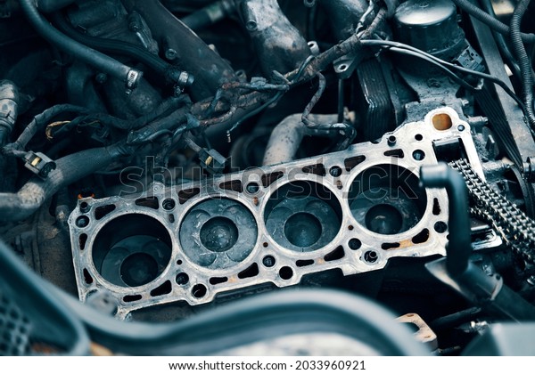 Auto mechanic working in garage. Repair service.\
The connecting rod, piston and cylinder block in a disassembled\
condition. maintenance repair at car service station for diagnosis.\
High quality photo