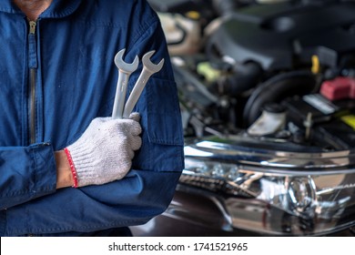 Auto mechanic working in the garage, Service and maintenance and car maintenance. - Powered by Shutterstock