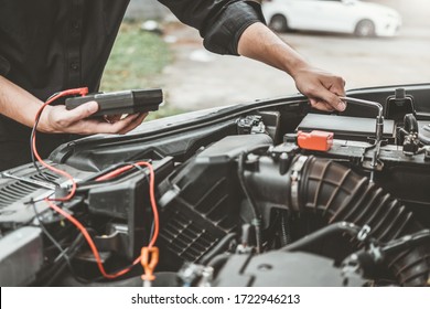Auto mechanic working in garage Technician Hands of car mechanic working in auto repair Service and Maintenance car battery check. - Shutterstock ID 1722946213