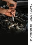 Auto mechanic working on car engine in mechanics garage. Repair service. Close-up shot. Free space for text, copy space