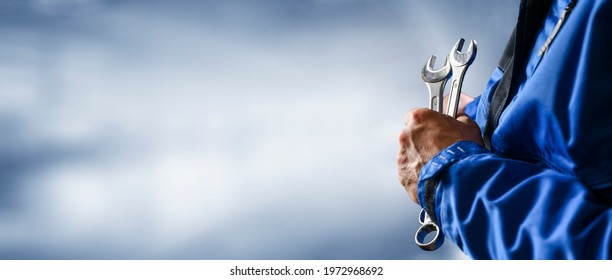 Auto mechanic working on car broken engine in mechanics service or garage. Transport maintenance wrench detial Wide banner or panorama photo. - Shutterstock ID 1972968692