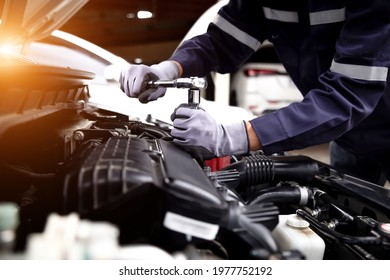 Auto mechanic working on car engine in mechanics garage.Repair service,car service, repair, maintenance concept.