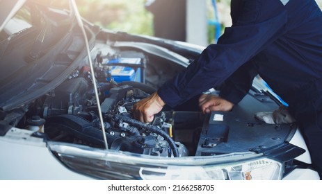 Auto Mechanic Working In Repair Service Garage. Repair Service Center Concept, Expert Repair Technicians In Modern Service Centers.