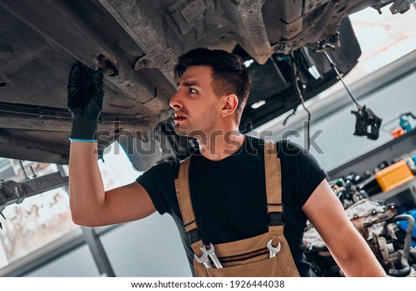 Auto
mechanic working at auto repair shop. Close up
view.