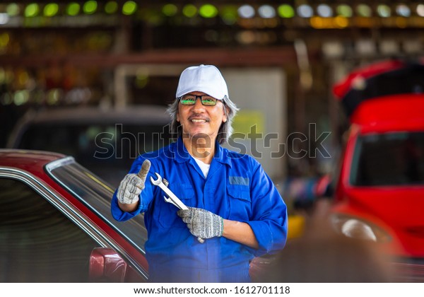 Auto mechanic working Repairing shock\
absorber.car service