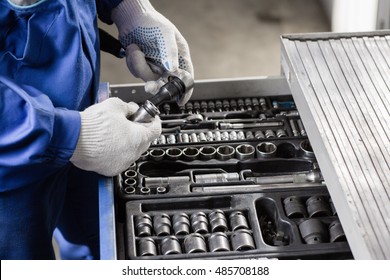 Auto Mechanic With Working Tools For Repair And Diagnostics Of Cars In The Garage Car