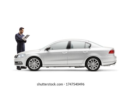 Auto Mechanic Writing A Document And Inspecting A Car Isolated On White Background