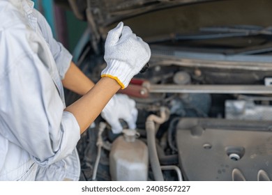 Auto mechanics diagnose engine problem using light tools to finde abnormal parts, ensuring safe vehicle performance. - Powered by Shutterstock