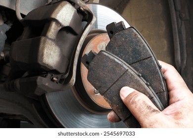 Auto mechanics replace worn brake pads to maintain a car braking system , Car maintenance concept