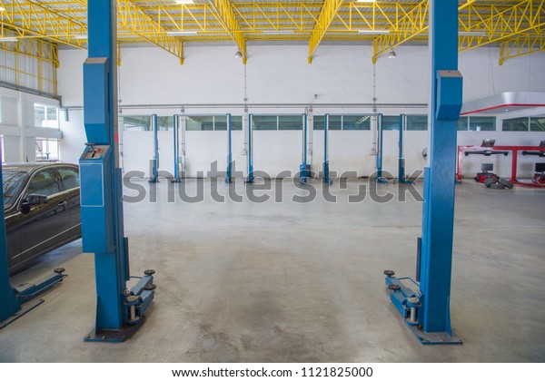 Auto mechanics\
working under the car - a series of MECHANIC related images.\
Interior of a car repair station, Image of a car repair / lifts\
Interior of a car repair\
station