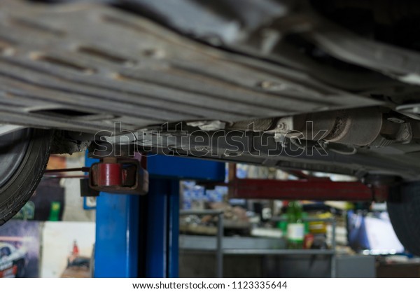 auto on the\
lift, car on service garage,\
servicing