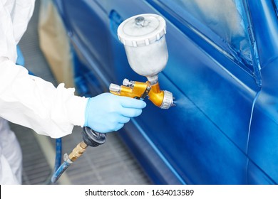 Auto Painting Service. Repaint Car Into Blue With Spray Paint Gun