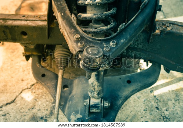 Auto Part Upper Arm Ball Joint and Coil Spring and\
Shock Absorber and Lower Arm and Chassis and Power Steering Rack of\
Car in Vintage Tone
