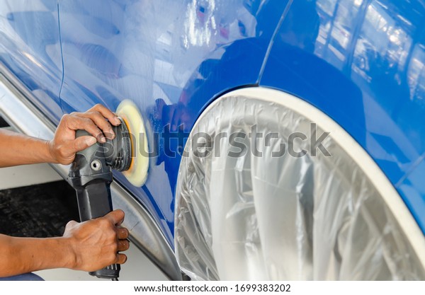 Auto polishing with machine.Blue car polish to\
remove and recover the\
car.
