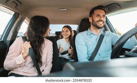 Auto purchase and rent. Happy caucasian family driving new automobile having test drive in city, enjoying road trip, panorama. Parents and child girl spending vacation traveling by car. - Powered by Shutterstock