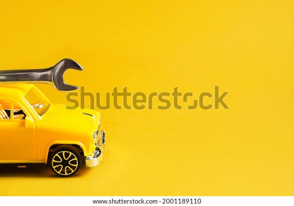 Auto repair and repair of equipment and cars,\
urgent departure of the master to eliminate breakage, plumbing\
work, construction. Repair service car with adjustable universal\
key on yellow background.