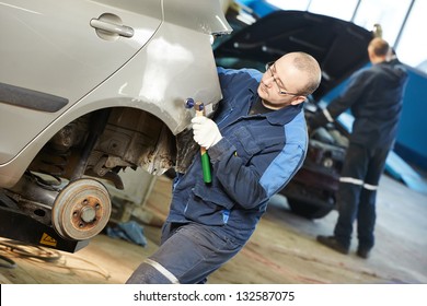 Auto Repair Man Worker Flatten And Align Metal Body Car With Hammer In Automotive Industry