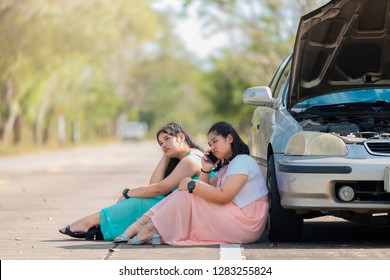 Auto Repair Service, Insurance Concept - Teen Driver Using Smartphone After Car Accident. Asian Woman Worry And Stress A Trouble With Car Engine Crash Overheat At The Side Of The Road.