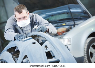 auto repairman grinding autobody bonnet - Powered by Shutterstock