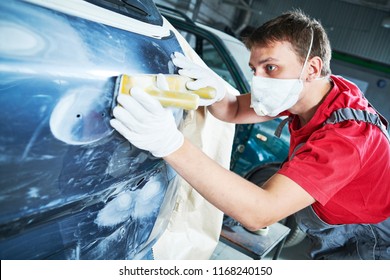 Auto Repairman Grinding Automobile Body