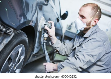 auto repairman grinding automobile car body - Shutterstock ID 630040232
