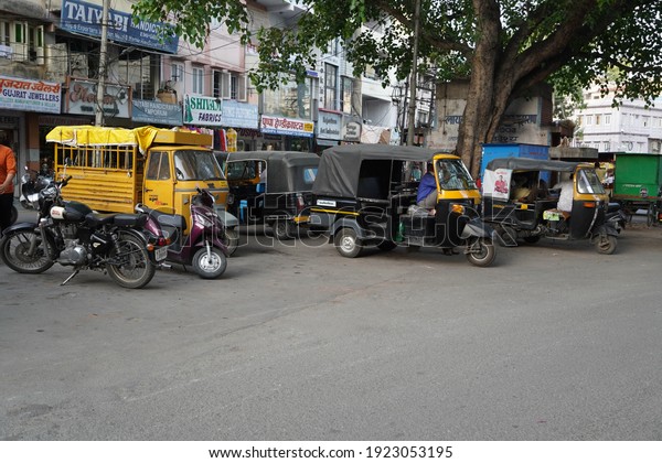 Auto rickshaws waiting\
for customers, parked at the side of the street. Udaipur India -\
August 2020 VP2M