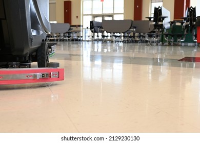 Auto Scrubber On A Floor In A School Cafeteria. Automated Floor Cleaning Machine In Public Space. Janitorial Maintenance