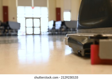 Auto Scrubber On A Floor In A School Cafeteria. Automated Floor Cleaning Machine In Public Space. Janitorial Maintenance