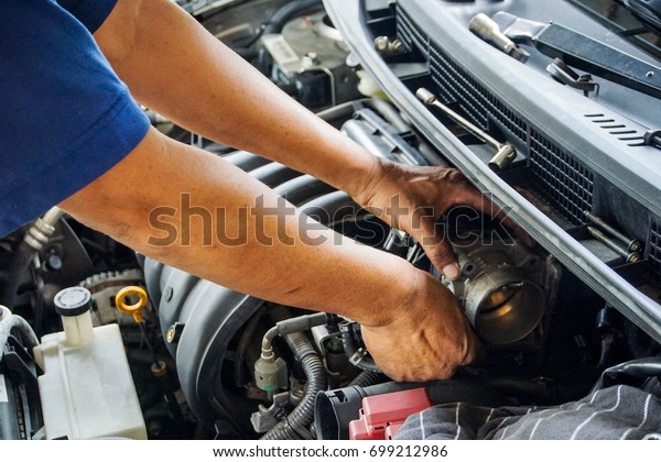 Auto Service Business\
Concept. Pro Car Mechanic Taking Care of Vehicle. Checking Under\
the Car Hood.