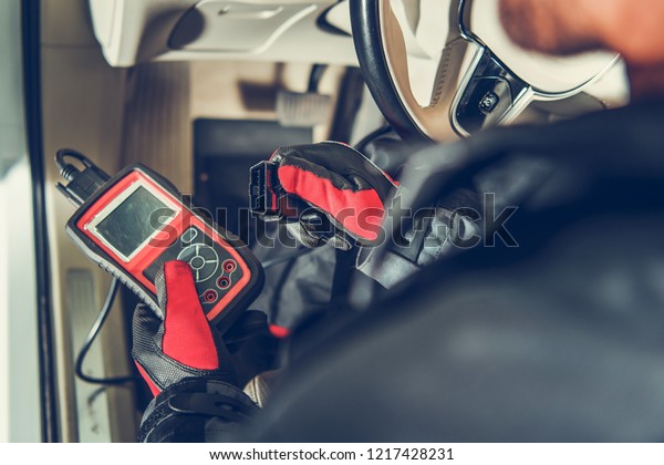 Auto Service\
Diagnostic Tool in Hands of Vehicle Maintenance Worker. Car\
Computer Error Reading Using Mobile Device.\
