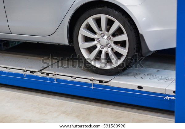 auto service and maintenance concept - car on
lift at repair station