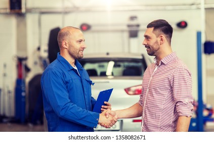 Auto Service, Repair, Maintenance, Gesture And People Concept - Mechanic With Clipboard And Man Or Owner Shaking Hands At Car Shop