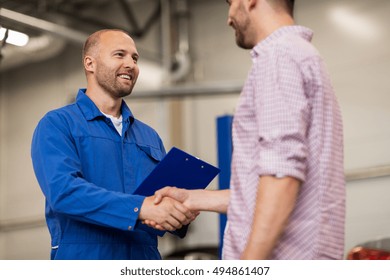 Auto Service, Repair, Maintenance, Gesture And People Concept - Mechanic With Clipboard And Man Or Owner Shaking Hands At Car Shop