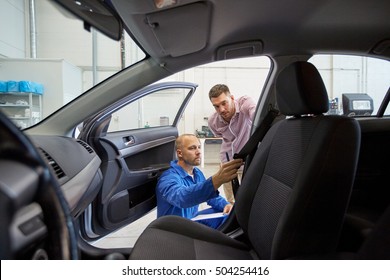 Auto Service, Repair, Maintenance And People Concept - Mechanic Checking Car Seat Belt With Man Or Owner At Workshop