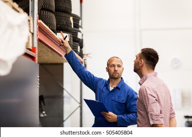 Auto Service, Repair, Maintenance And People Concept - Mechanic With Clipboard Showing Tire To Man At Car Shop