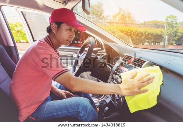 Auto\
service staff cleaning car with microfiber\
cloth