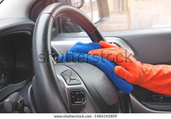 Auto service staff\
cleaning car interior