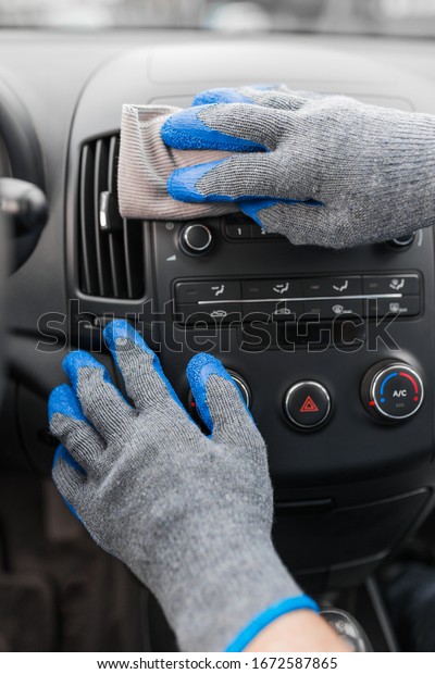 Auto service staff hand\
cleaning car interior with microfiber cloth. Car detailing and\
valeting concept
