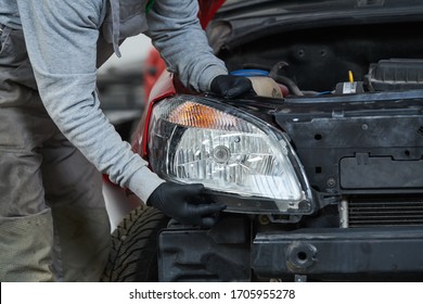 Auto Service. Technician Assembling An Automobile Headlight Lamp. Bodywork Repair For Insurance