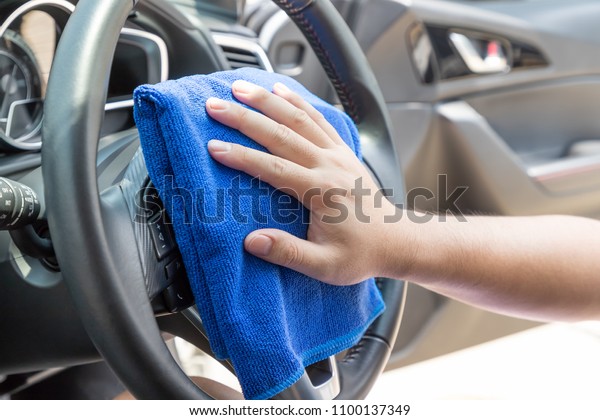 Auto service worker cleaning inside car with micro
fiber cloth