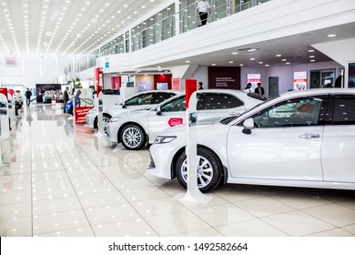 Auto showroom. Toyota brand cars are in a row, polished beautiful modern cars with a shiny surface reflecting beautiful light illumination in the hall. Copy space. Shymkent Kazakhstan April 15, 2019
