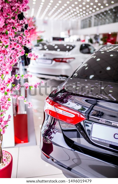Auto showroom. Toyota brand cars are in a row,\
polished beautiful modern cars with a shiny surface reflecting\
beautiful light illumination in the hall. Copy space. Shymkent\
Kazakhstan April 15, 2019