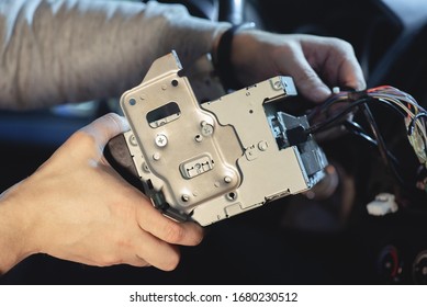 Auto Technician Is Installing A New Car Radio Player Close Up.