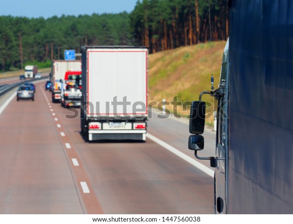 Autobahn. Cars\
and trucks, traffic on the\
highway