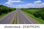 Autobahn, expressway, motorway in Germany in summer. View from the bridge. Beautiful blue sky with white clouds.