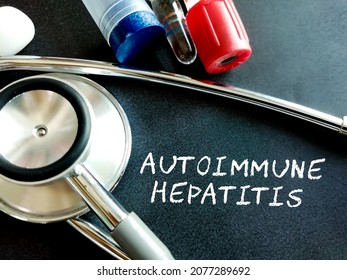 Autoimmune hepatitis written on black background with medical equipment's.